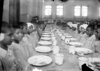 Huerfanos en el comedor de un hospicio antes de comer