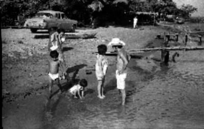Familia de turistas jugando en una playa