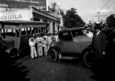 Gente observando un automóvil después de un accidente