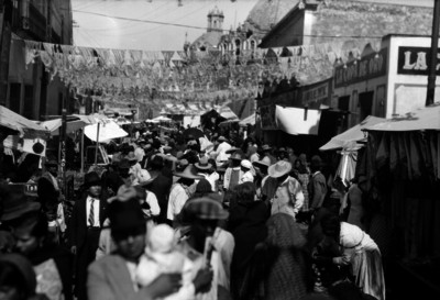 Gente transita por una calle con puestos comerciales