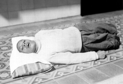Enfermo mental racostado sobre una almohada, en el suelo del manicomio La Castañeda