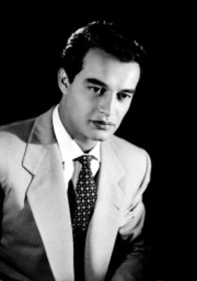 Jaime Fernández, actor, viste de traje y corbata decorada, retrato