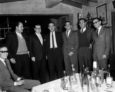 Hombres de pie, reunidos en una casa, retrato de grupo