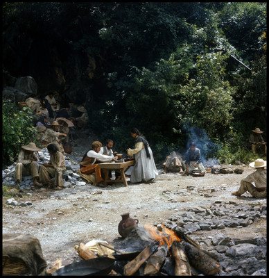 Escena de hombres comiendo en el campo